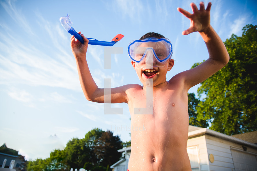 a boy child in goggles and a snorkel 