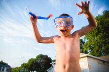 a boy child in goggles and a snorkel 