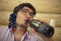 Man Grapes Behind Ear Drinks wine