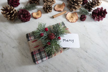 wrapped gift and tag labeled - mercy 