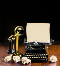 Antique typewriter and old brass stick telephone