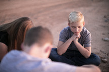 praying kids in a desert 