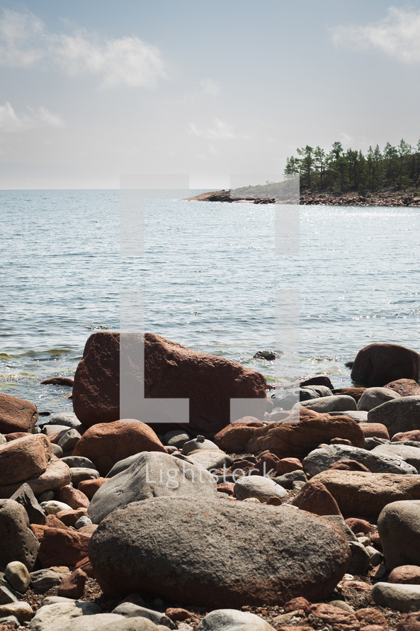 Rocks and pebbles in front of the sea