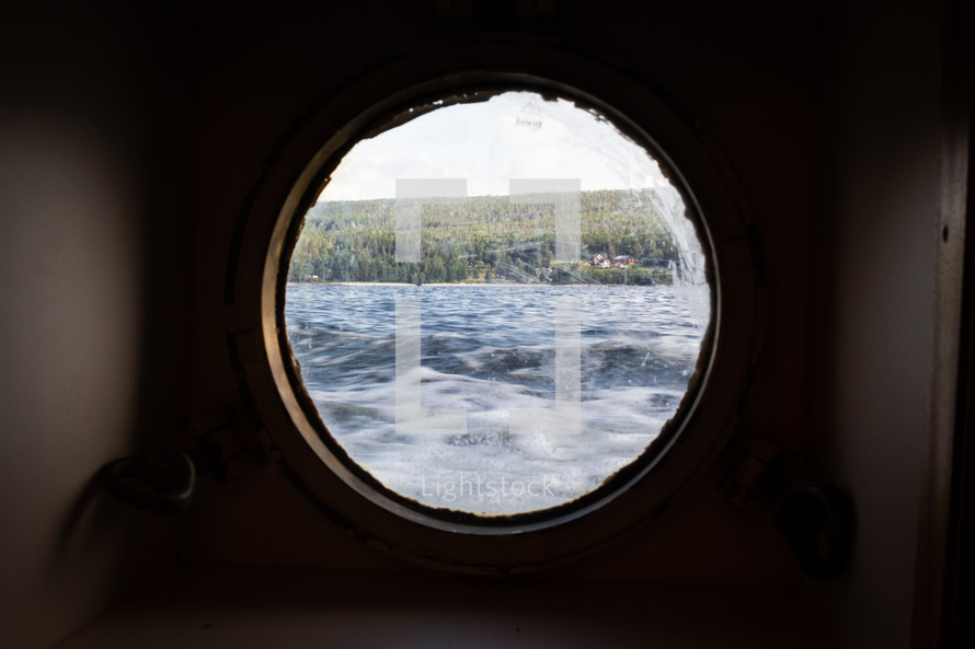 Land in sight from the window of a boat