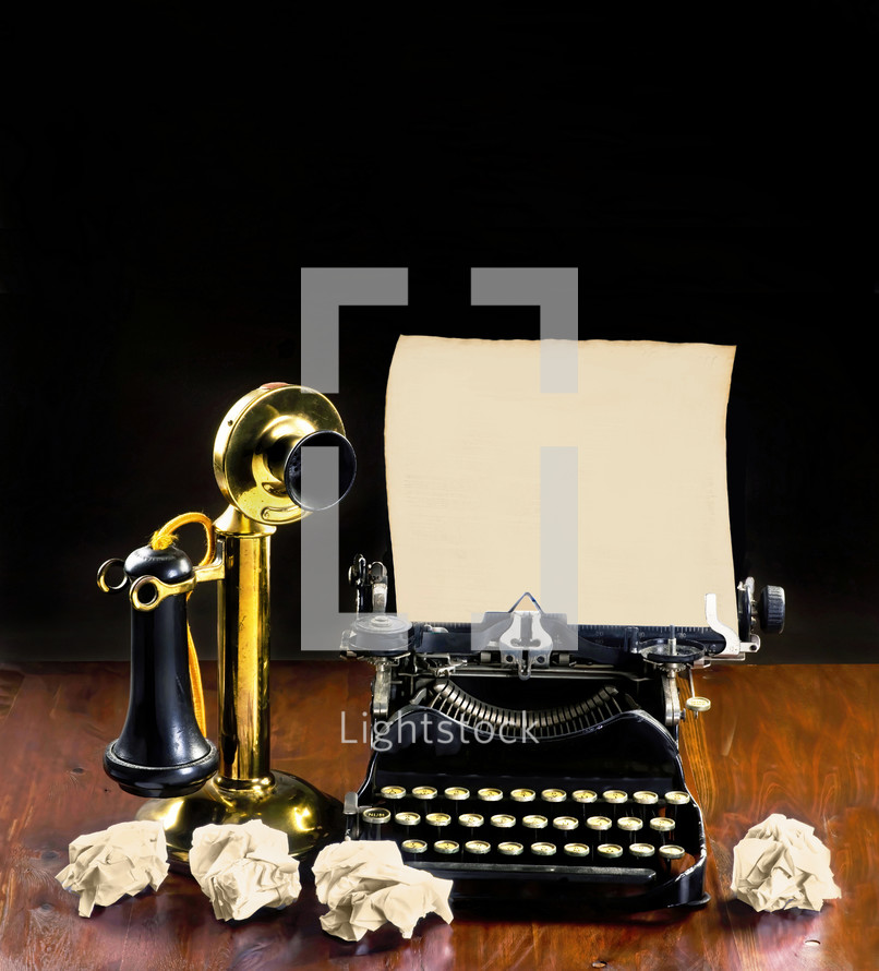 Antique typewriter and old brass stick telephone