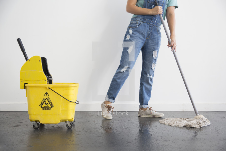 a woman mopping a floor 