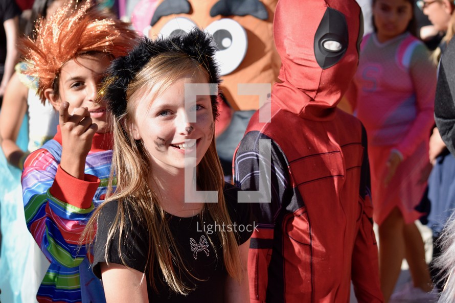 smiling girl in a Halloween costume at a parade 