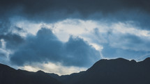 cloudy skies over mountains 