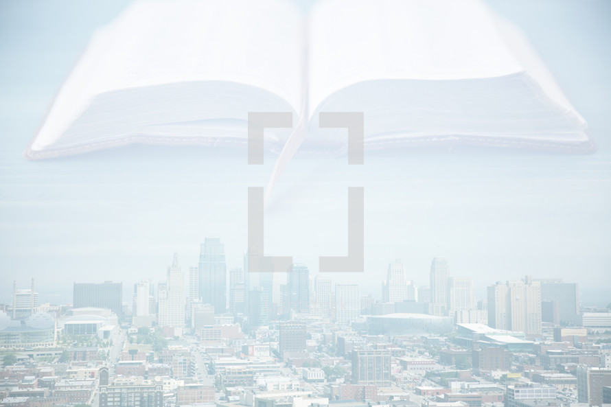 A Bible hovering over a large city.