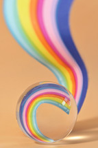 A Glass Round Lens ball and Paper Rainbow reflection 