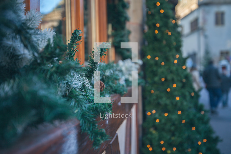 Christmas garland and Christmas tree on store fronts 
