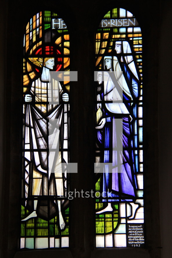 Stained Glass Window proclaiming 'He is Risen'.