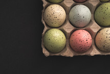 speckled dyed Easter Eggs in a carton 