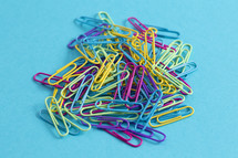 pile of rainbow colored paperclips 
