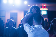 laying on of hands during a worship service 