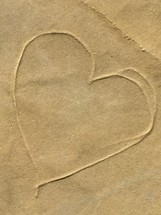 a heart drawn in sand 