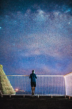 a man looking up at the stars