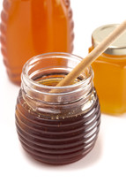 container of honey on a white background 