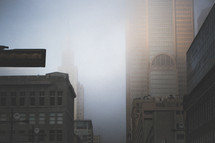 city skyscrapers in dense fog 