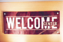 welcome center sign on a door 
