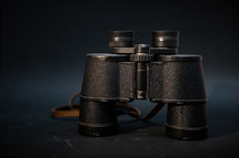 black binoculars on a black background