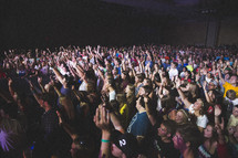 raised hands by concert goers at a concert 