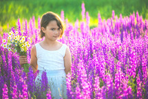 a girl in a field of purple flowers 
