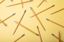 sharpened pencils on a yellow background 