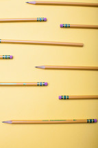sharpened pencils on a yellow background 