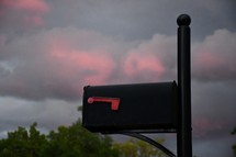 mail box and pink clouds at sunset 