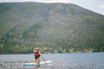 a woman on a paddle board 