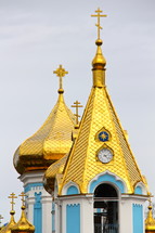 gold plated church steeples with orthodox crosses