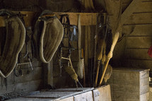 horse tack, horse gear, saddles, brooms, stable, barn, farm, harness