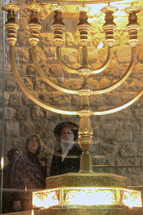 Observers viewing a seven-lamp Menorah at the Western Wall.