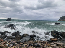 waves crashing into a rocky shore 