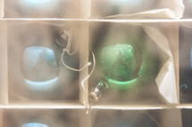 a photo of 2 vintage Christmas ornaments behind frosted glass