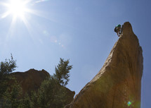 a man climbing a rock wall 