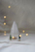 Bokeh lights with Christmas trees against white background 
