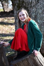 portrait of a smiling teen girl wearing red and green at Christmas 