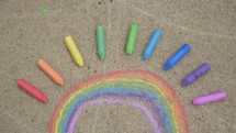 a rainbow of sidewalk chalk 