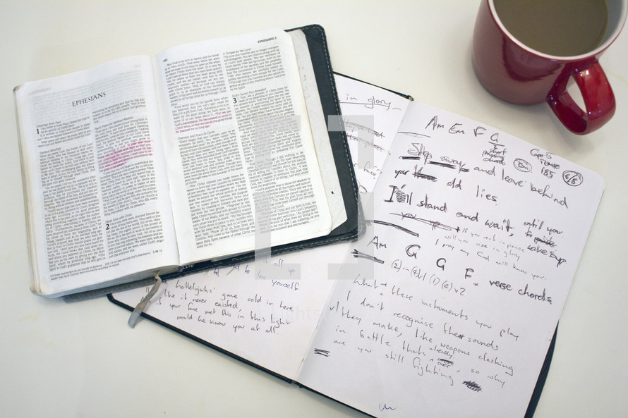 open Bible, notebook, journal, coffee mug