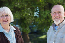 portrait of a mature couple standing together outside.