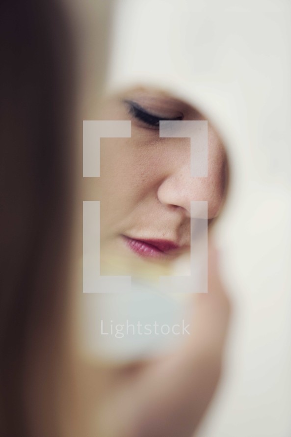 woman looking in a mirror 