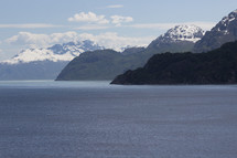 snow capped mountain peaks and ocean 