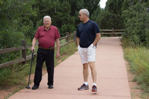 father and son walking together on a path 