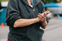 an elderly woman with clasped hands 