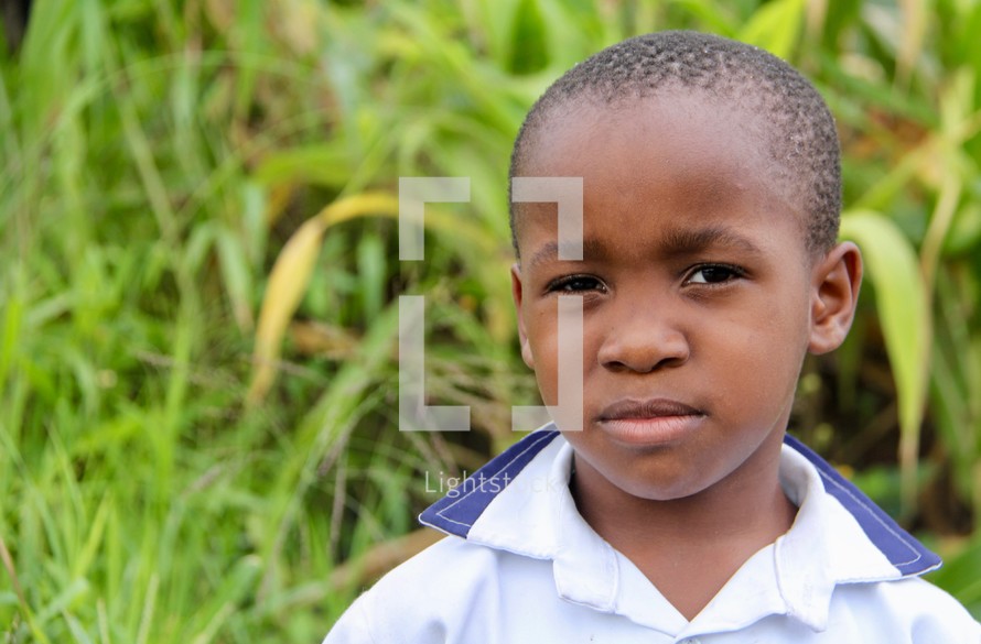 face of a young boy in a school uniform 