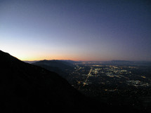 Cityscape, with mountain range during sunrise.