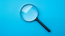 Magnifying glass on a blue background. 