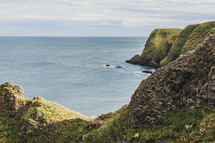 green cliffs along a shoreline 